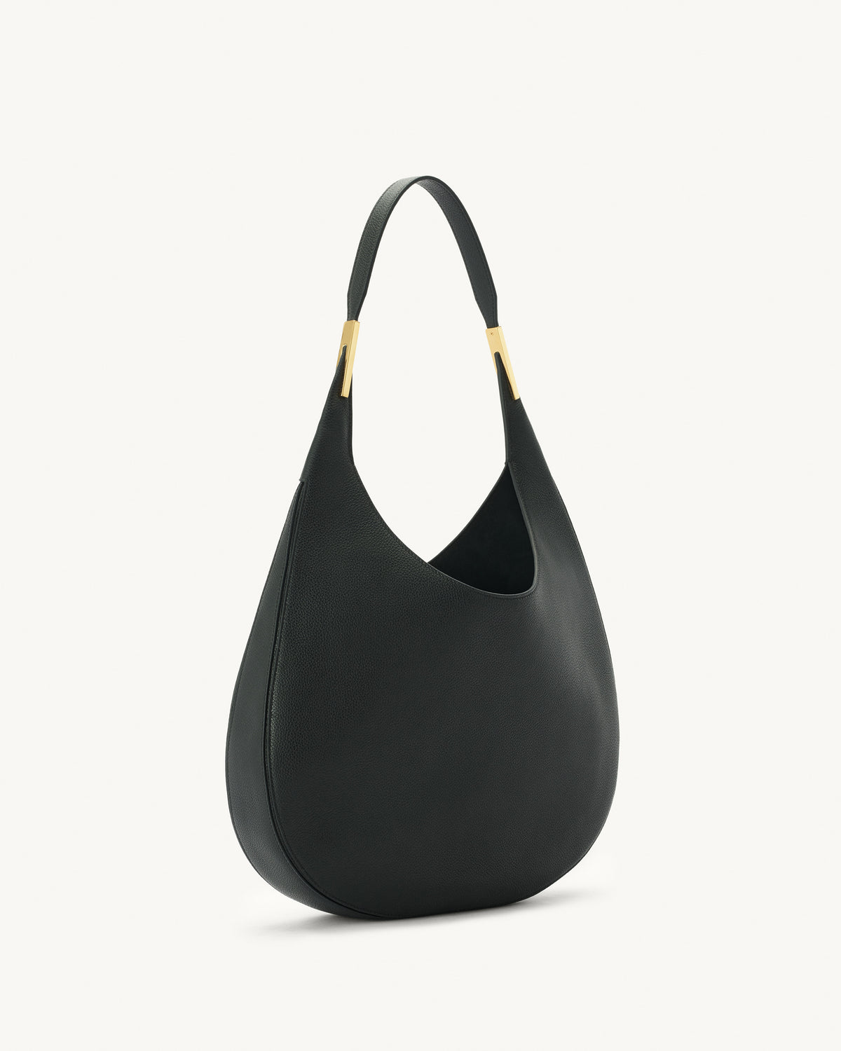 side view of black bag with gold hardware on a white background