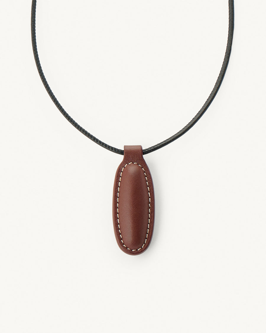 front view of espresso brown leather pendant on a white background