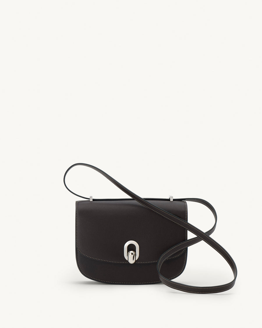 front view of a currant brown bag with silver clasp on a white background