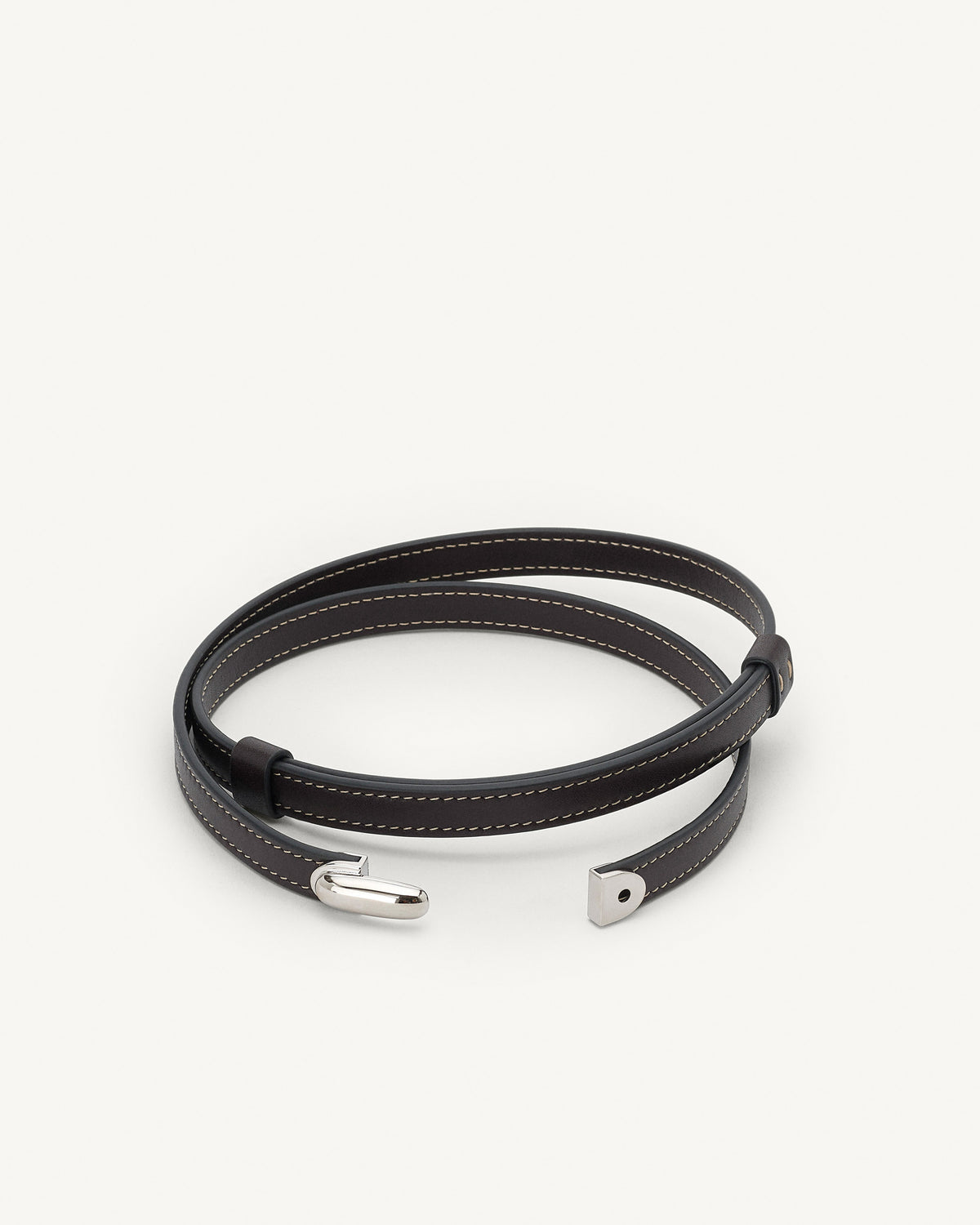 front view of a currant brown belt with silver clasp on a white background