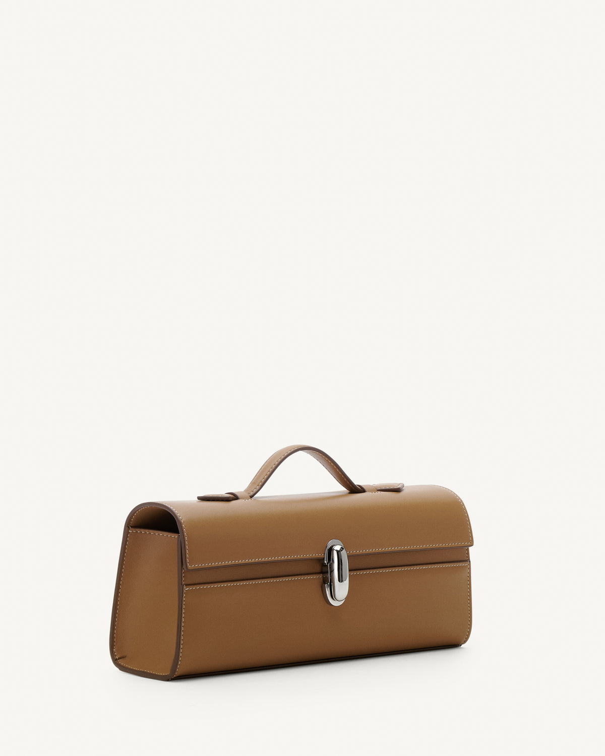 Side view of Saddle leather handbag with a silver clasp on a white background