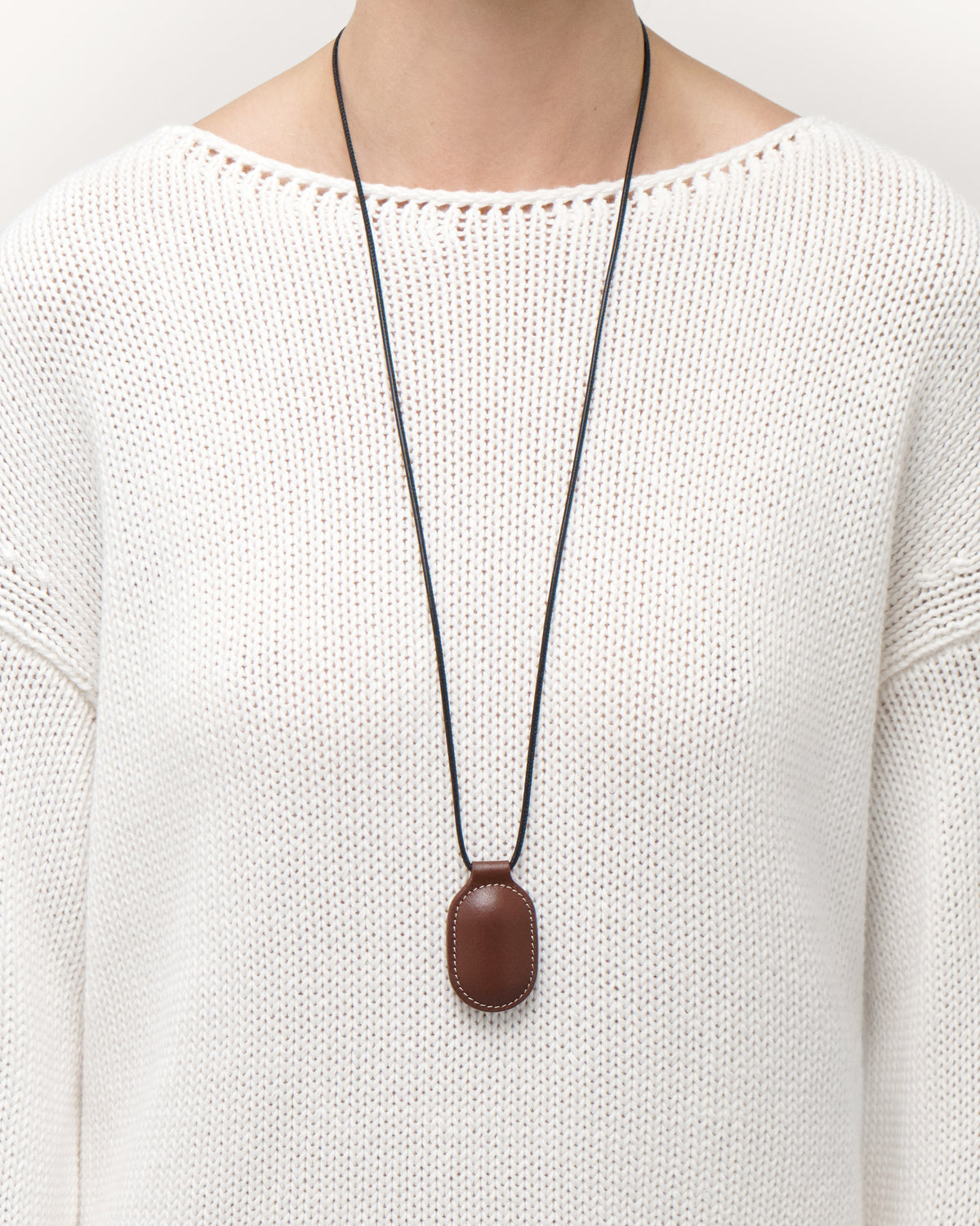 on model view of espresso brown leather pendant on a white background