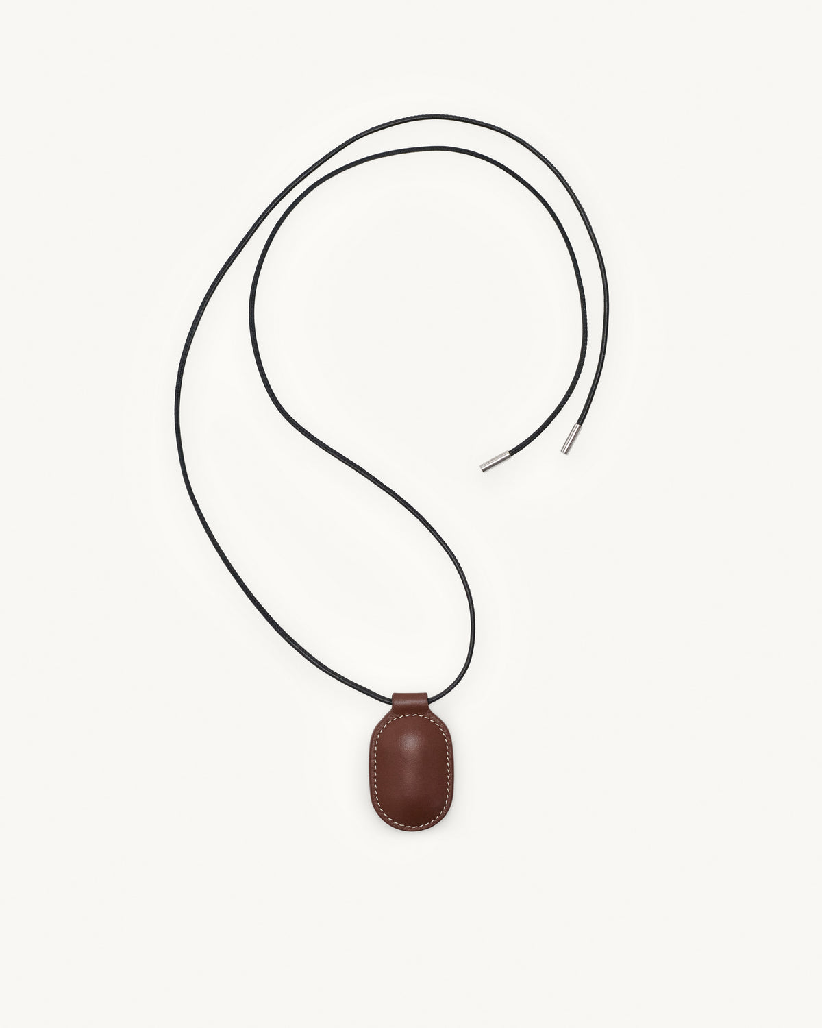 top view of espresso brown leather pendant on a white background