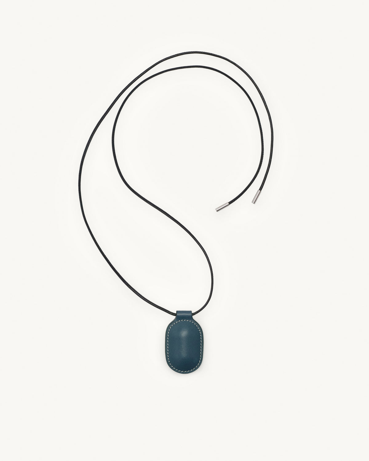 top view of ocean blue leather pendant on a white background