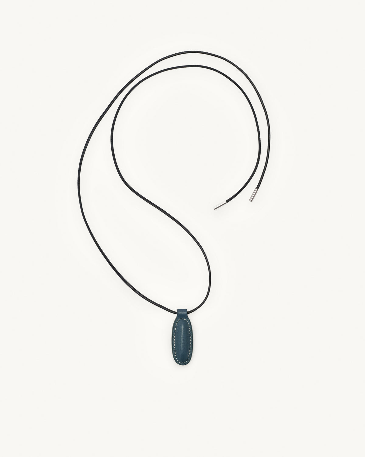 top view of ocean blue leather pendant on a white background