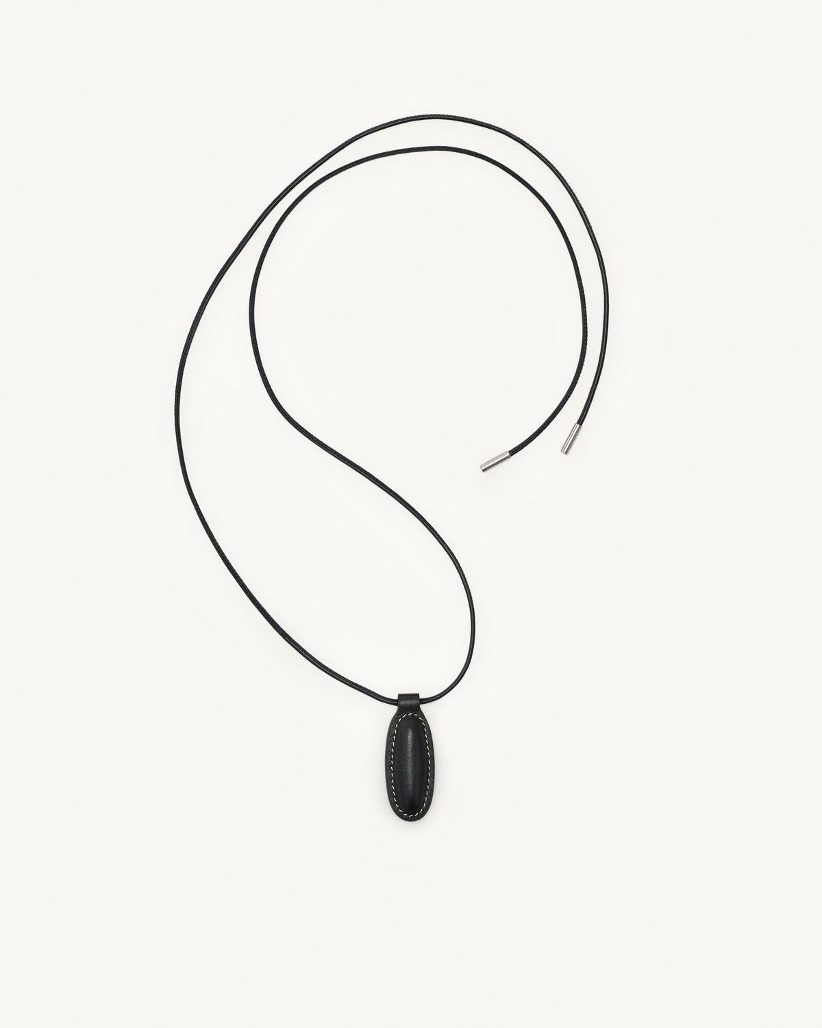 top view of black leather pendant on a white background