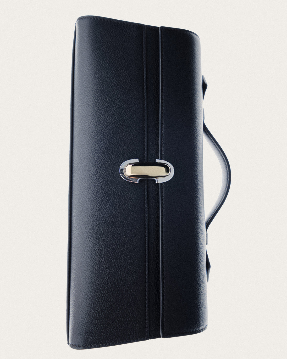 campaign image of black leather bag with gold and silver clasp on a white background