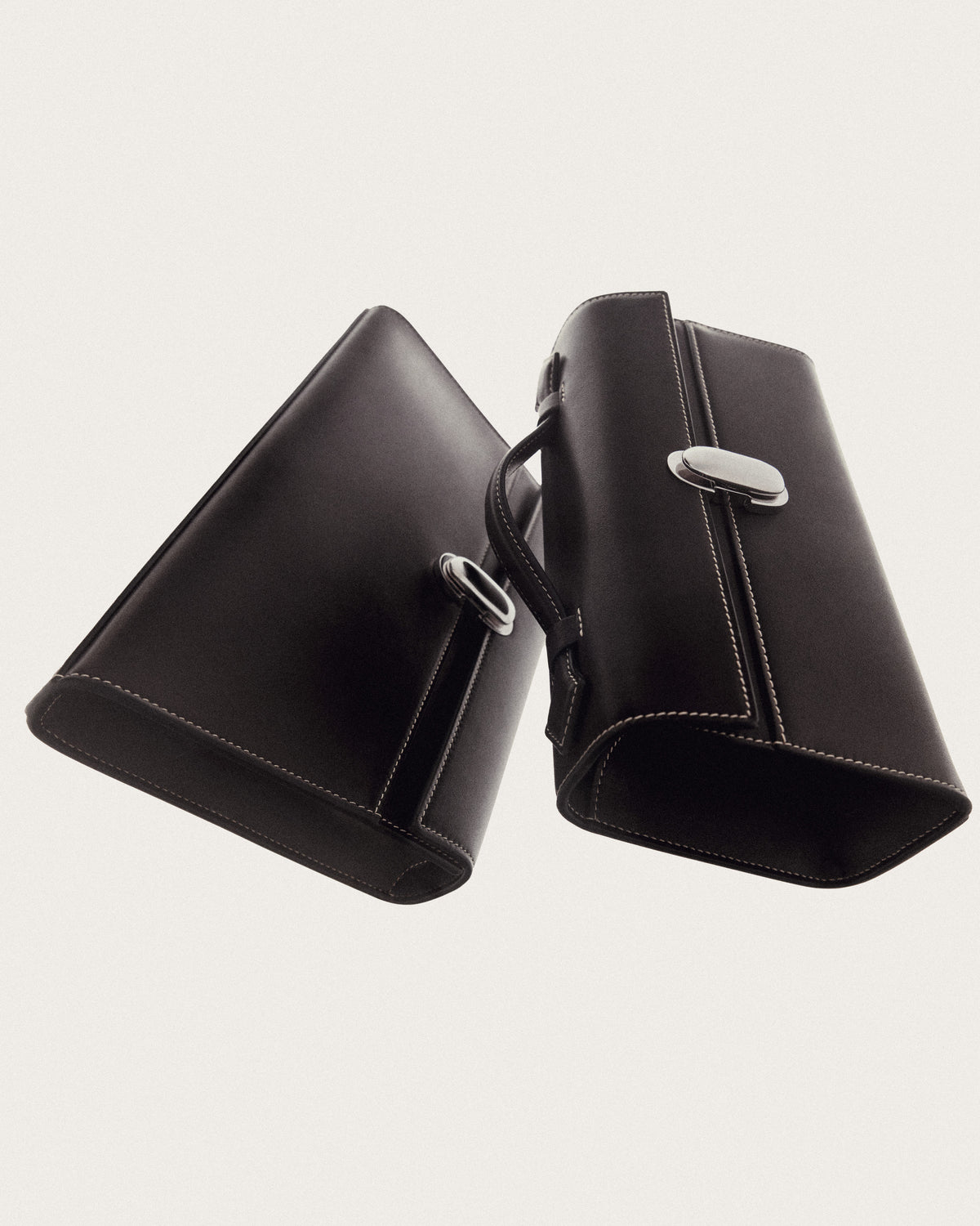 campaign image of two currant brown bags with silver clasps on a white background
