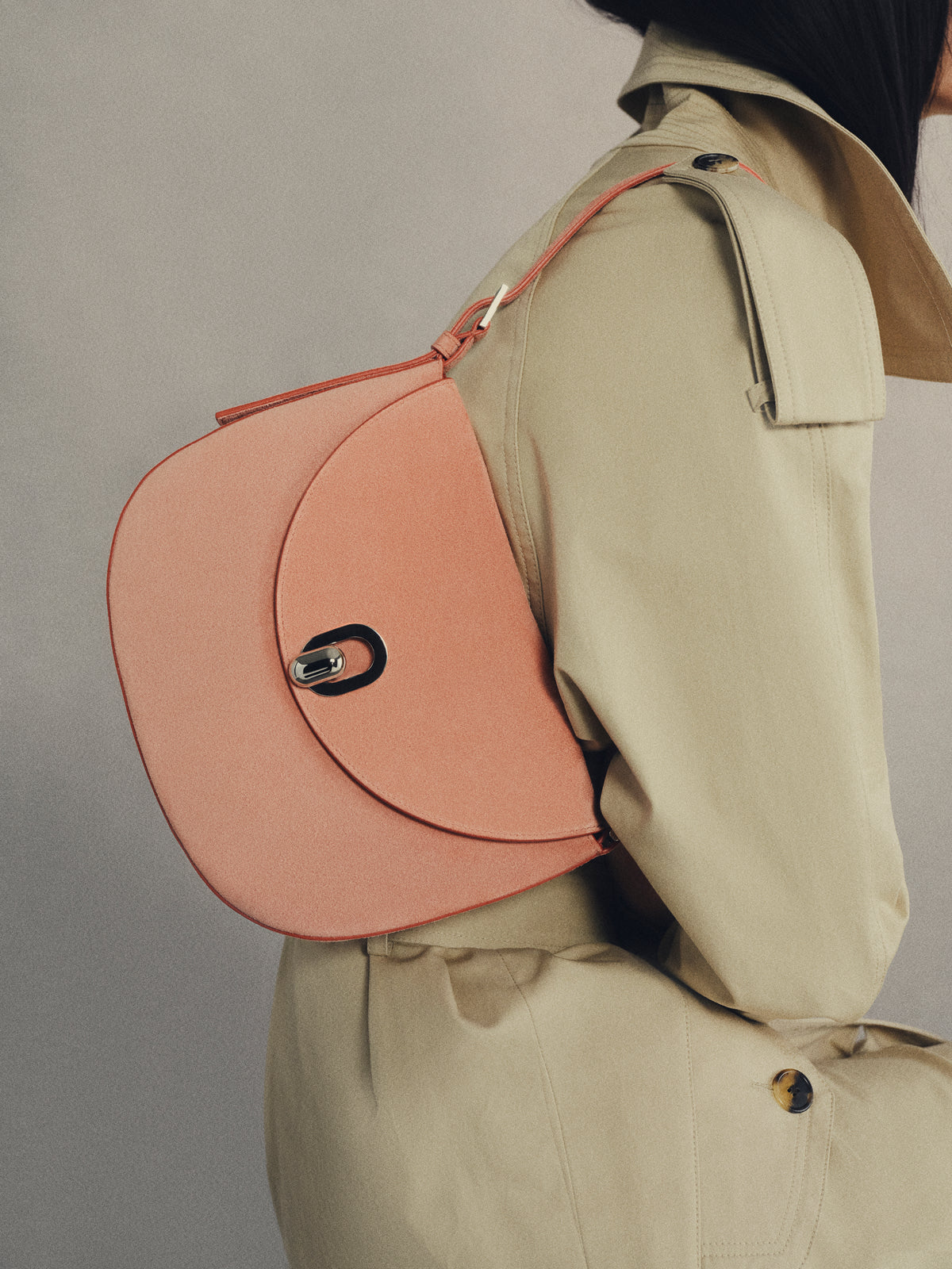 Woman sitting holding pink Tondo Hobo handbag