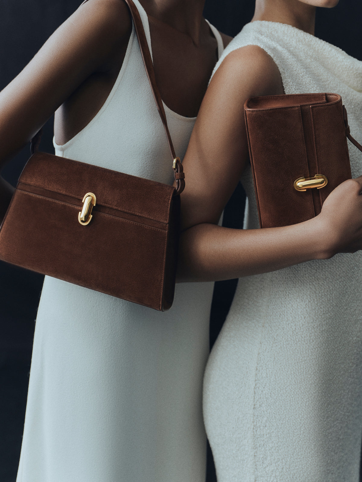 campaign on model image of two espresso brown suede bags with gold clasps