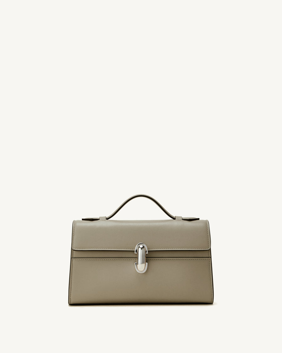 front view of a clay beige bag with a silver clasp on a white background
