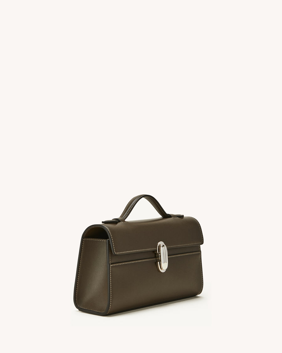 side view of a mink brown bag with silver clasp on a white background