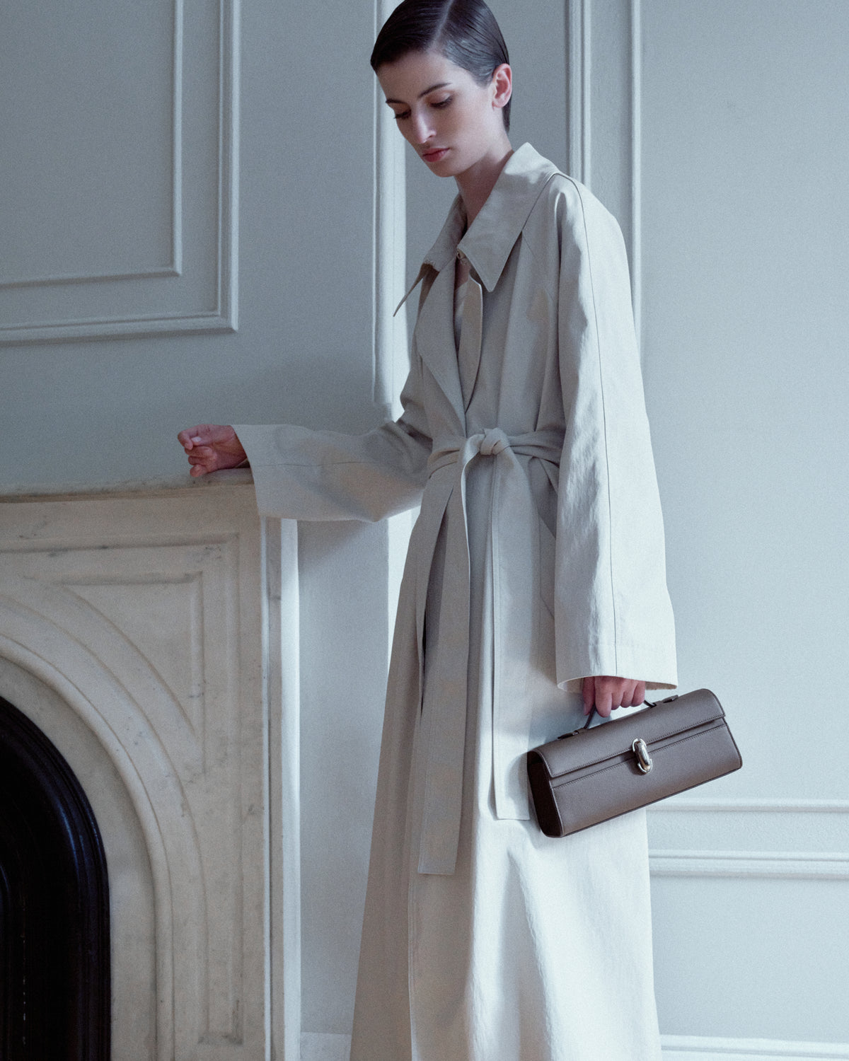 campaign on model image of a mink brown leather bag with a silver clasp