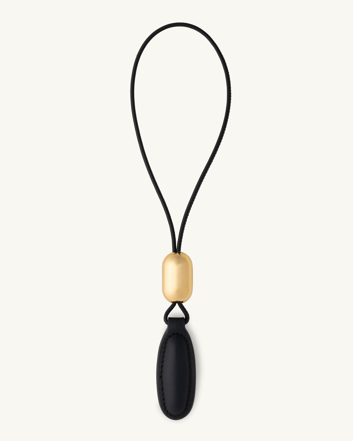 front view of a black leather charm on a white background
