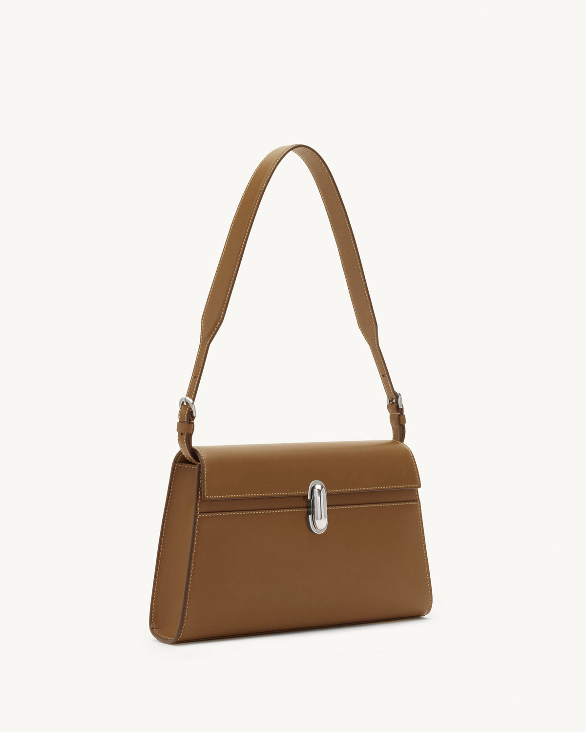 side view of a saddle brown leather bag with a silver clasp on a white background